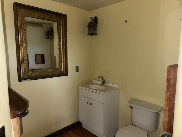 bathroom with vanity, wood-type flooring, and toilet