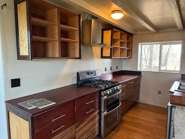 kitchen with double oven range, beam ceiling, light hardwood / wood-style floors, and wall chimney exhaust hood