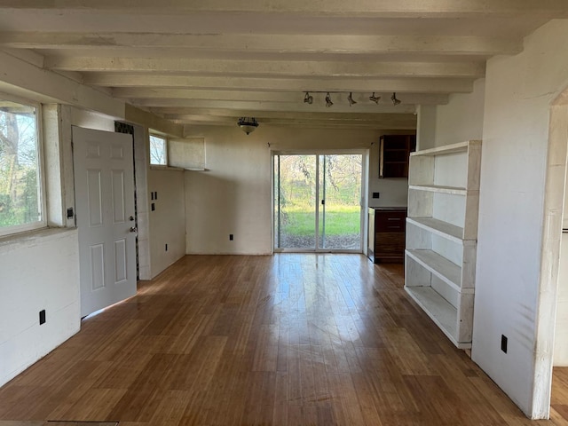 interior space featuring beamed ceiling and hardwood / wood-style floors