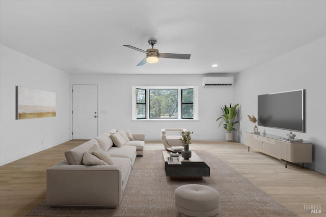 living room with light hardwood / wood-style flooring, a wall mounted AC, and ceiling fan