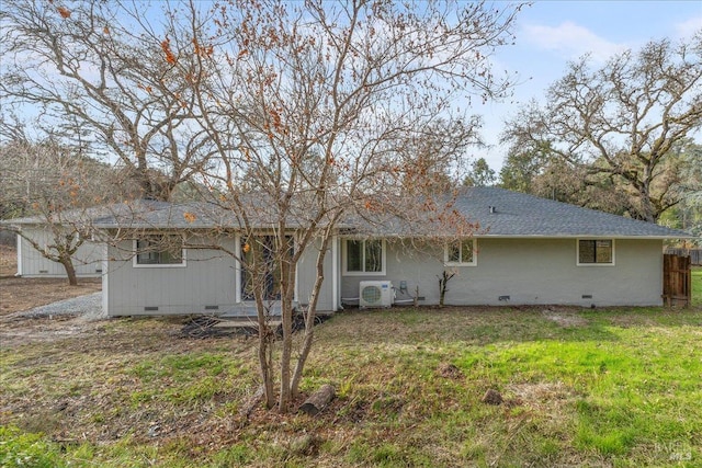 rear view of house featuring a lawn and ac unit