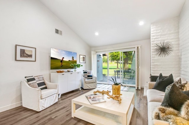 living room with visible vents, recessed lighting, high vaulted ceiling, and wood finished floors