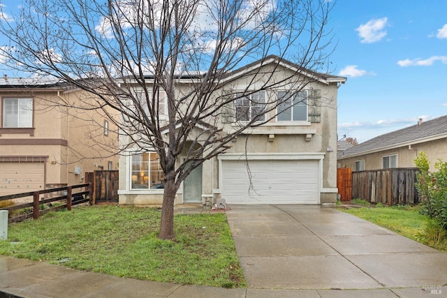 view of property featuring a front yard and a garage