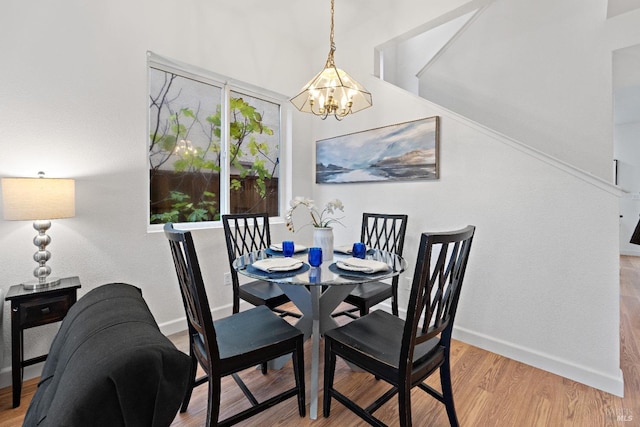 dining space with a chandelier and light hardwood / wood-style floors