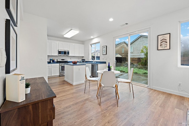 dining area featuring sink and light hardwood / wood-style flooring