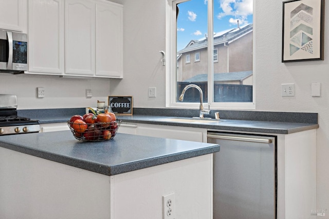 kitchen featuring sink, white cabinets, and appliances with stainless steel finishes