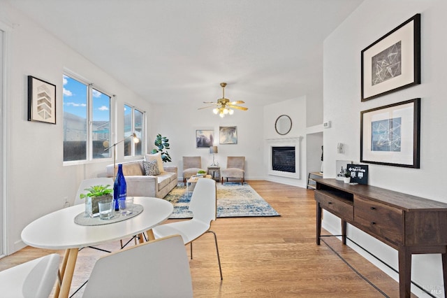 dining room with ceiling fan and light wood-type flooring