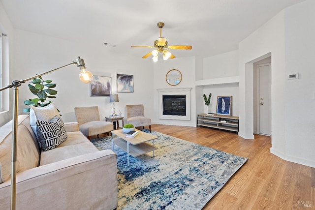 living room featuring hardwood / wood-style flooring and ceiling fan