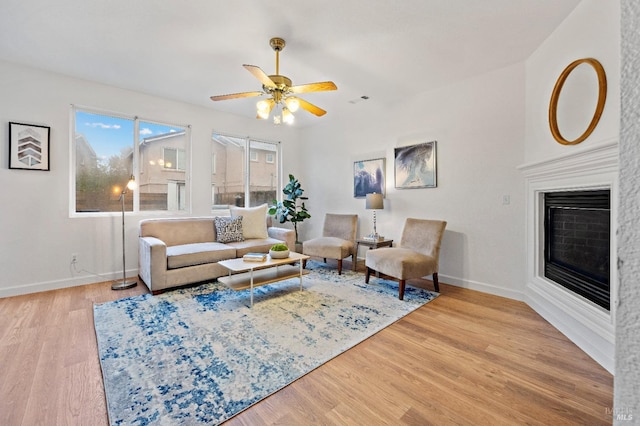 living room featuring ceiling fan and hardwood / wood-style floors