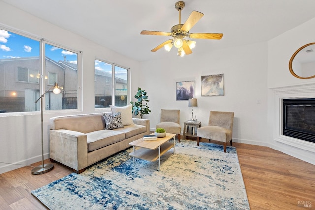 living room featuring hardwood / wood-style flooring and ceiling fan