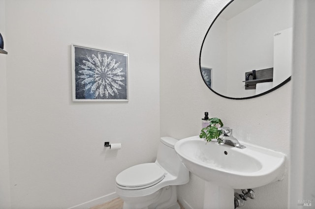 bathroom featuring toilet and sink