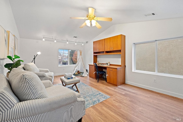 living room with ceiling fan, light wood-type flooring, and lofted ceiling