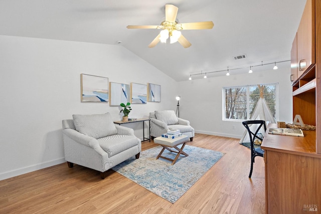 interior space with ceiling fan, track lighting, light hardwood / wood-style floors, and vaulted ceiling