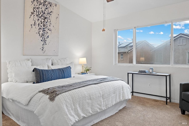 carpeted bedroom featuring ceiling fan and lofted ceiling