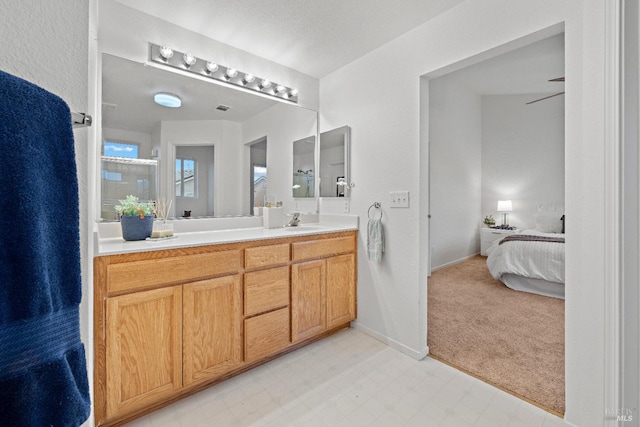 bathroom featuring ceiling fan and vanity