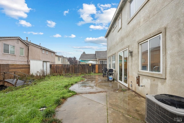 view of yard featuring central AC and a patio area