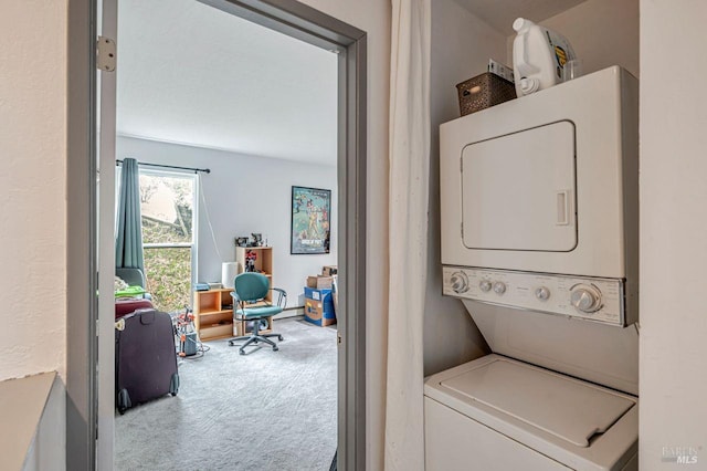 clothes washing area with stacked washer and dryer and carpet floors