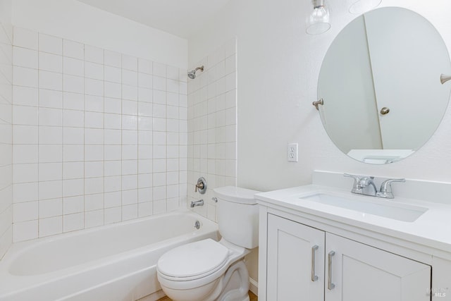 full bathroom with vanity, toilet, and tiled shower / bath combo