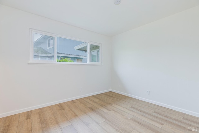 spare room with light hardwood / wood-style flooring