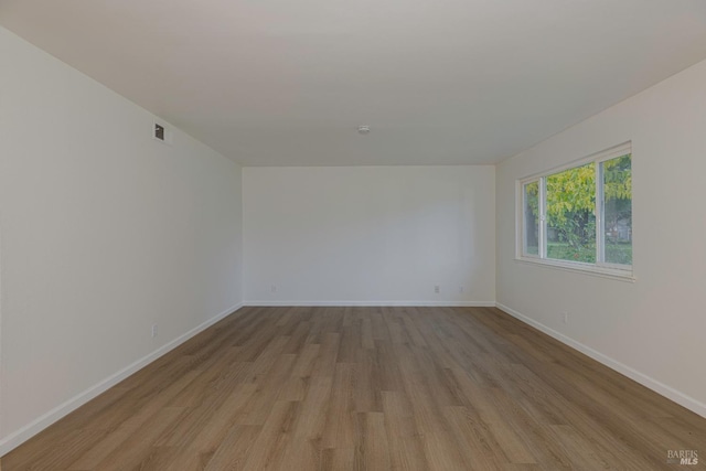 spare room featuring light hardwood / wood-style flooring