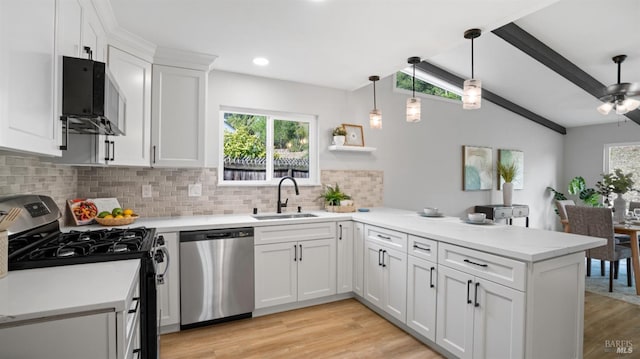 kitchen with black gas range oven, white cabinetry, dishwasher, sink, and kitchen peninsula