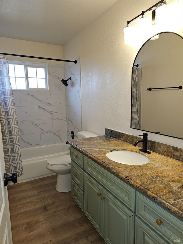 full bathroom with hardwood / wood-style flooring, shower / bath combination with curtain, toilet, and vanity