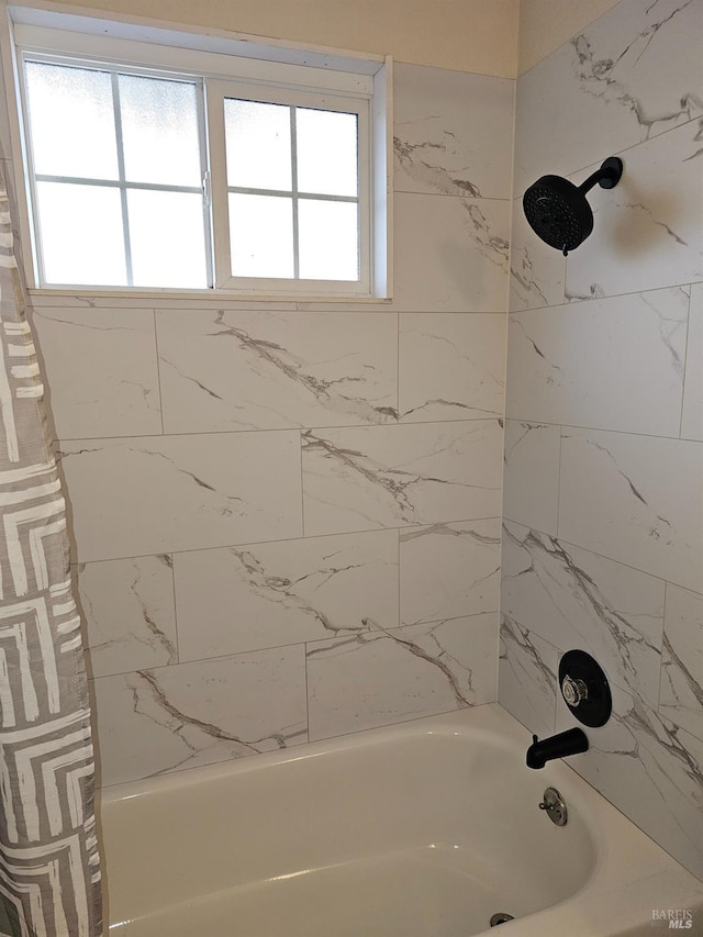 bathroom featuring a healthy amount of sunlight and shower / tub combo