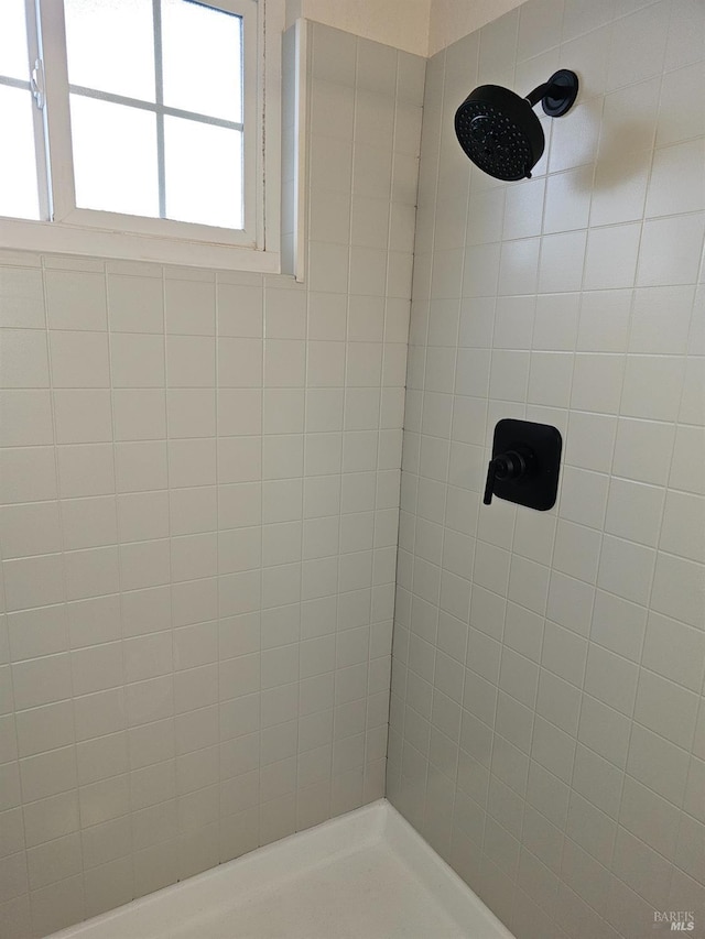 bathroom with tiled shower