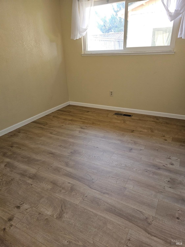 unfurnished room featuring light hardwood / wood-style floors