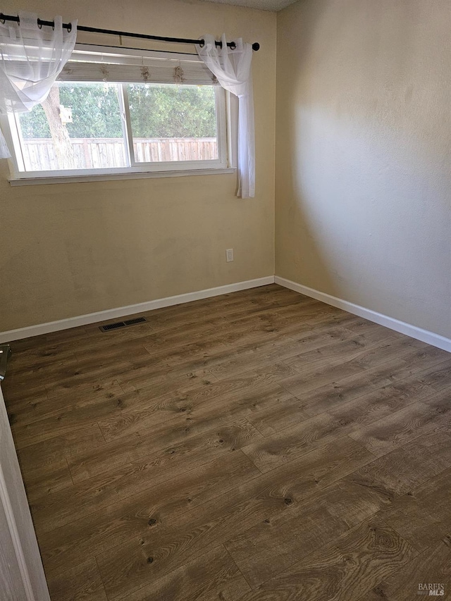 spare room featuring dark hardwood / wood-style floors