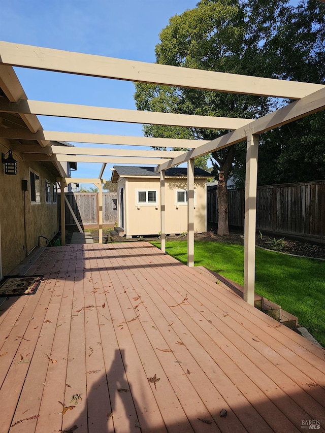 wooden deck with a pergola, a storage shed, and a lawn