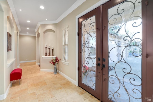 entryway featuring ornamental molding and french doors