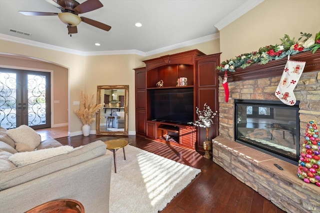 living room featuring french doors, crown molding, ceiling fan, and dark wood-type flooring