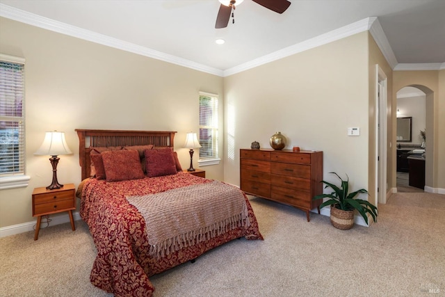 carpeted bedroom featuring ceiling fan, ornamental molding, and multiple windows