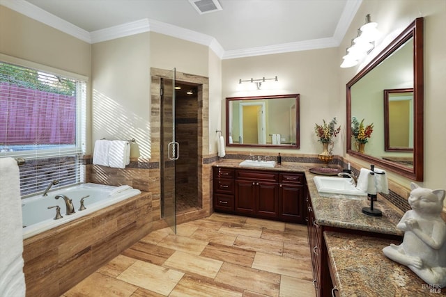 bathroom with vanity, crown molding, and independent shower and bath