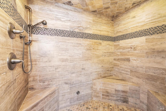 bathroom with a tile shower