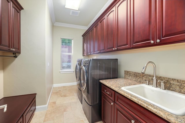 washroom with cabinets, crown molding, independent washer and dryer, and sink