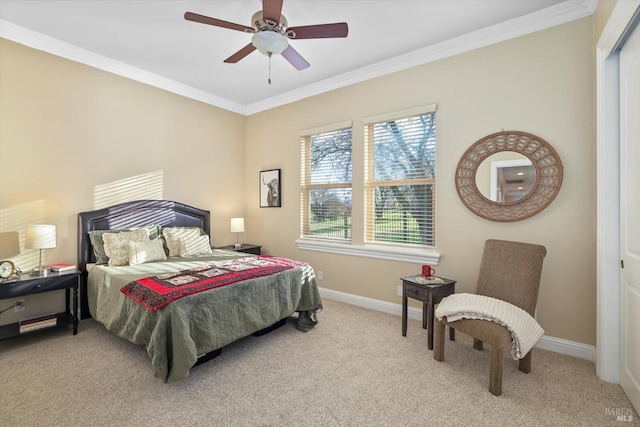 carpeted bedroom with ceiling fan, ornamental molding, and a closet