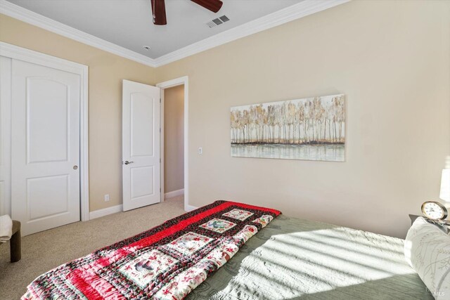 bedroom featuring carpet flooring, ceiling fan, a closet, and ornamental molding