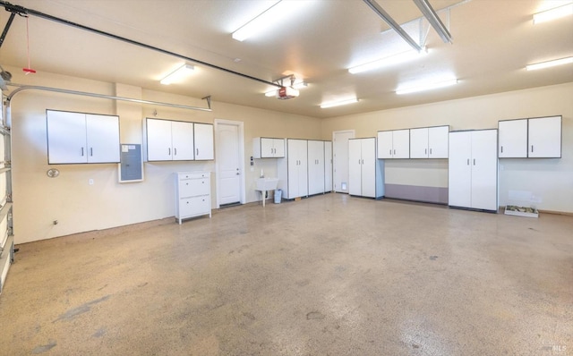 garage with electric panel, sink, and a garage door opener