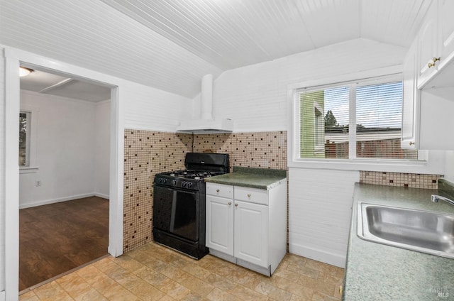 kitchen featuring white cabinetry, lofted ceiling, sink, and gas stove