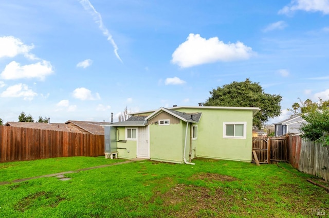 rear view of house with a yard