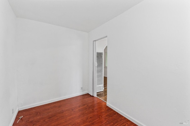 spare room featuring dark hardwood / wood-style floors