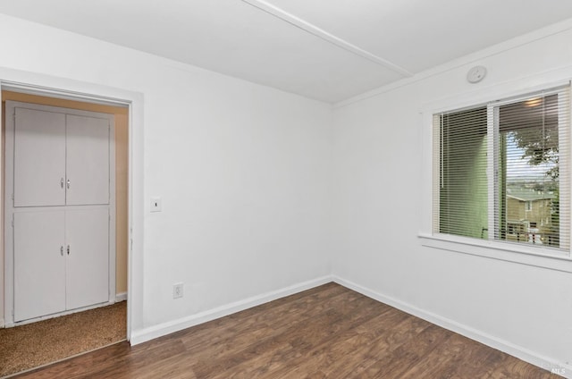 empty room with dark hardwood / wood-style flooring