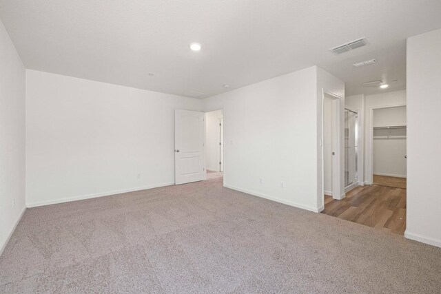 unfurnished room featuring light carpet