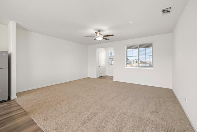 unfurnished living room featuring ceiling fan and light wood-type flooring