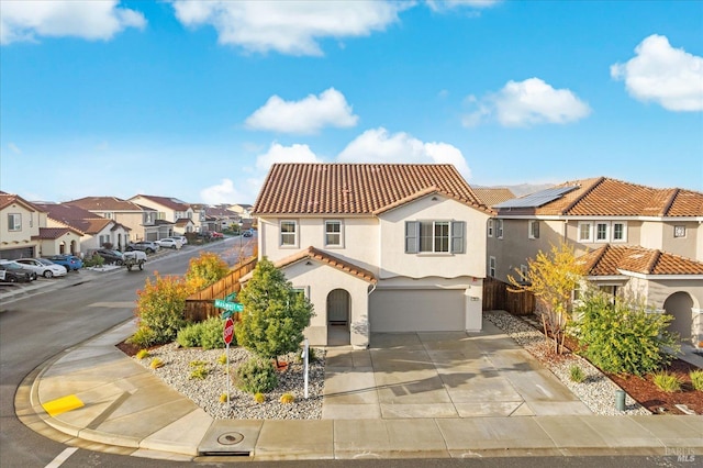 mediterranean / spanish-style house featuring a tiled roof, stucco siding, a residential view, and fence