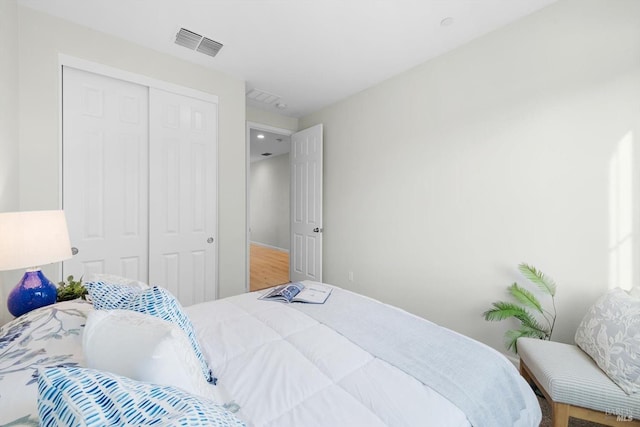 bedroom with a closet and visible vents