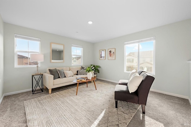 living room with a healthy amount of sunlight, baseboards, and carpet floors