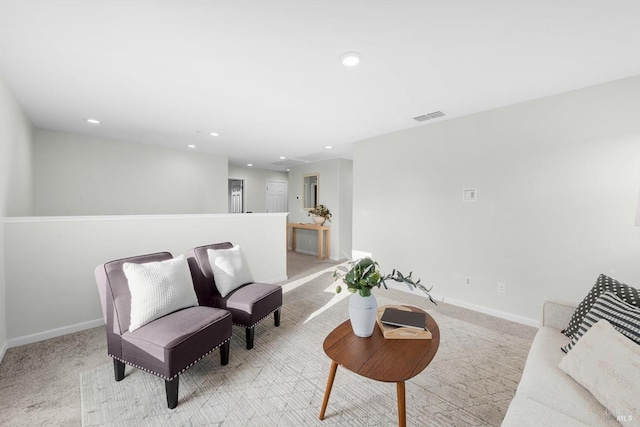 sitting room featuring visible vents, baseboards, and carpet